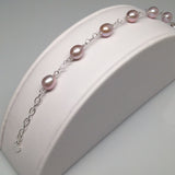 CLASSIC 7-STONE 7x8.5mm Naturally Pink Oval Freshwater Pearl Interlocking Heart Bracelet